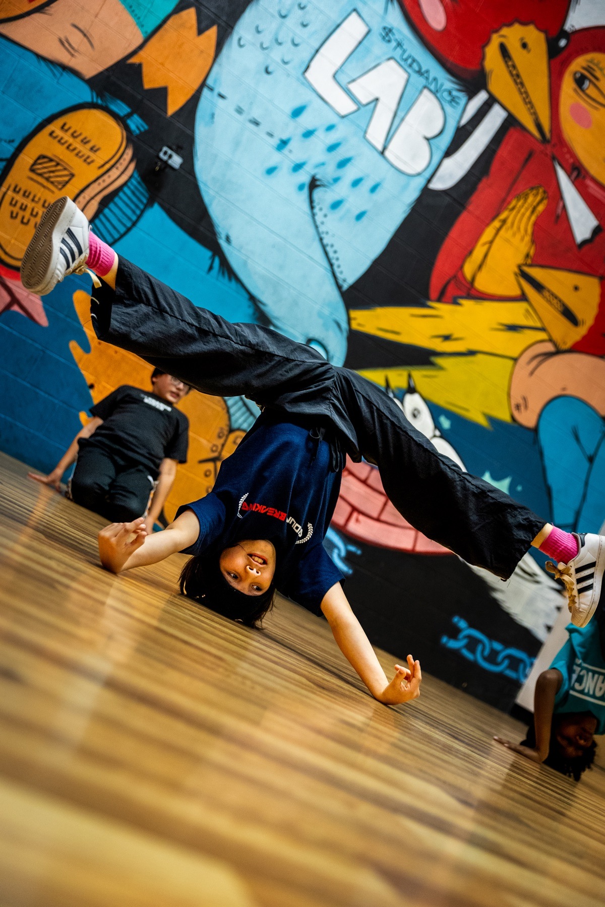 Young breakdancer practicing an inverted freeze at The Studance Lab