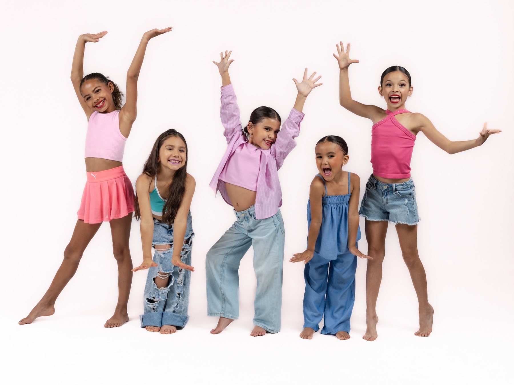 Young Studance Lab dancers posing together in colorful costumes