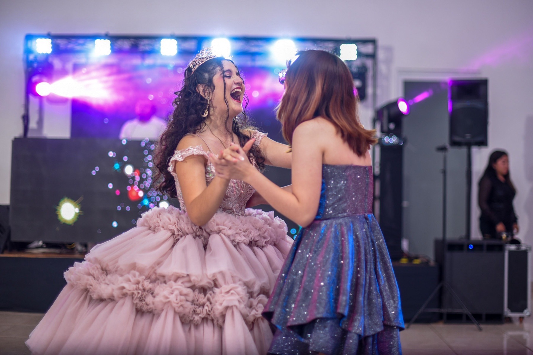 Quincea&ntilde;era celebrating on the dance floor with a friend
