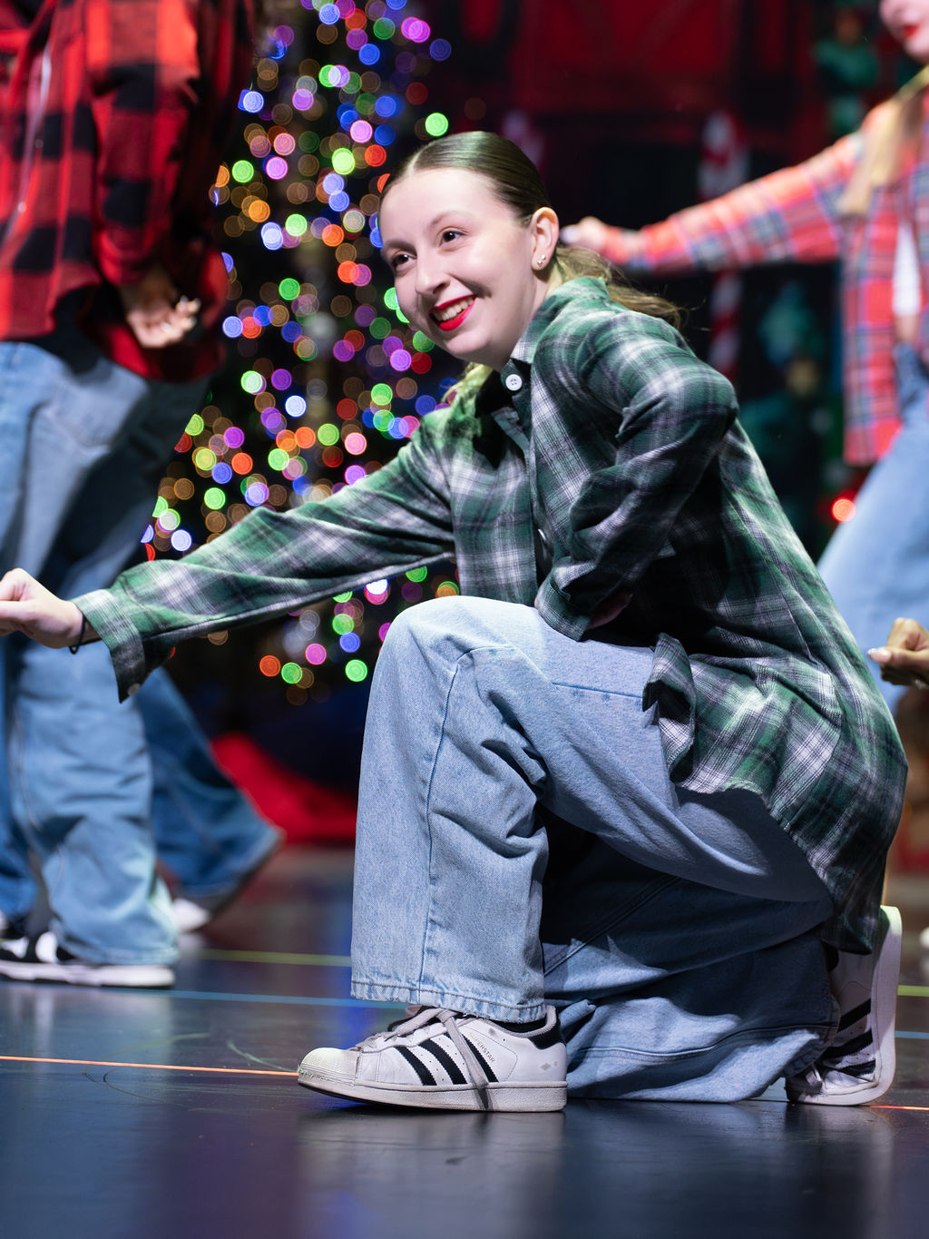 A hip hop dancer smiles during a holiday performance